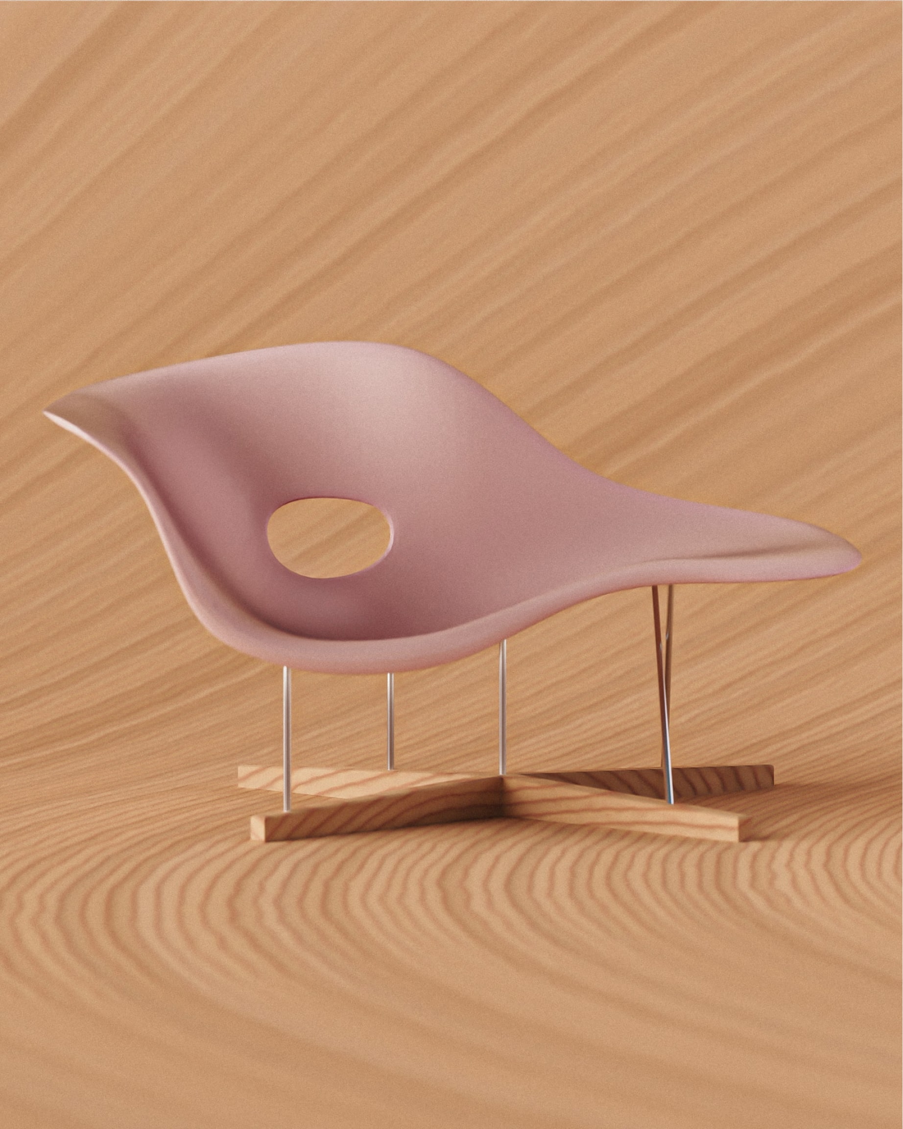 Pink La Chaise lounge chair on wooden surface
